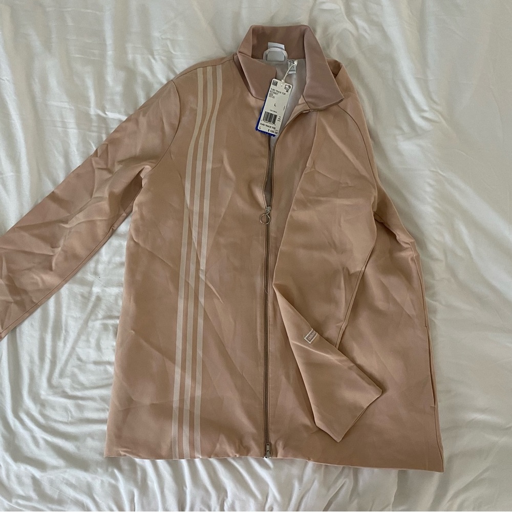 Adidas track jacket with tags still on. Never been worn.